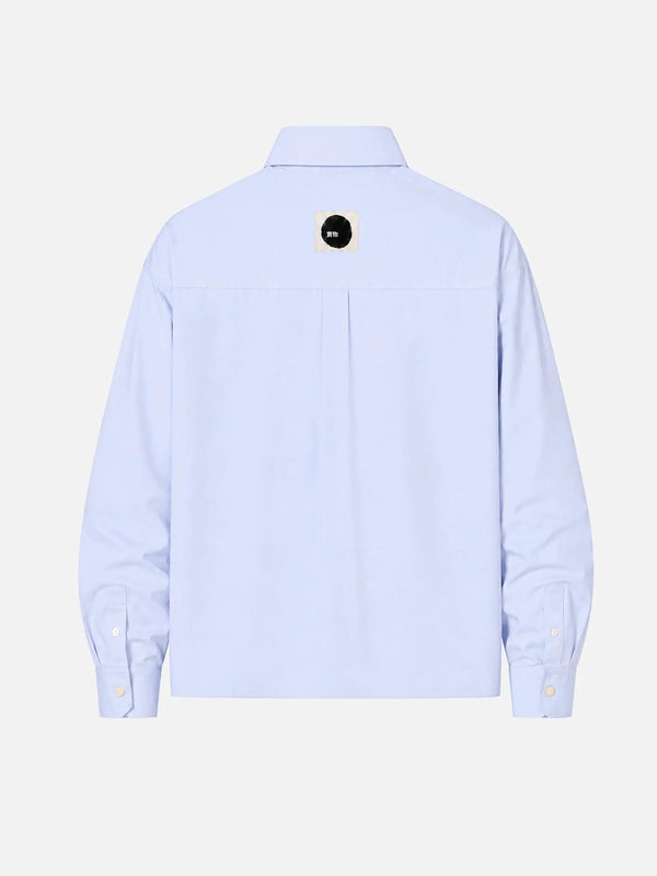 shopi go Meguro Regular Shirt – açık mavi, arka görünüm, küçük siyah daire logolu etiket